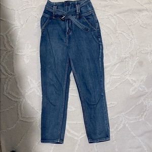Medium Wash jeans with corset-like high waist.